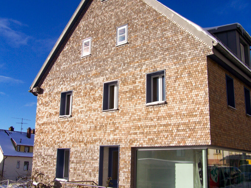 Hausfassade mit Holzschindeln aus Laerche gespalten